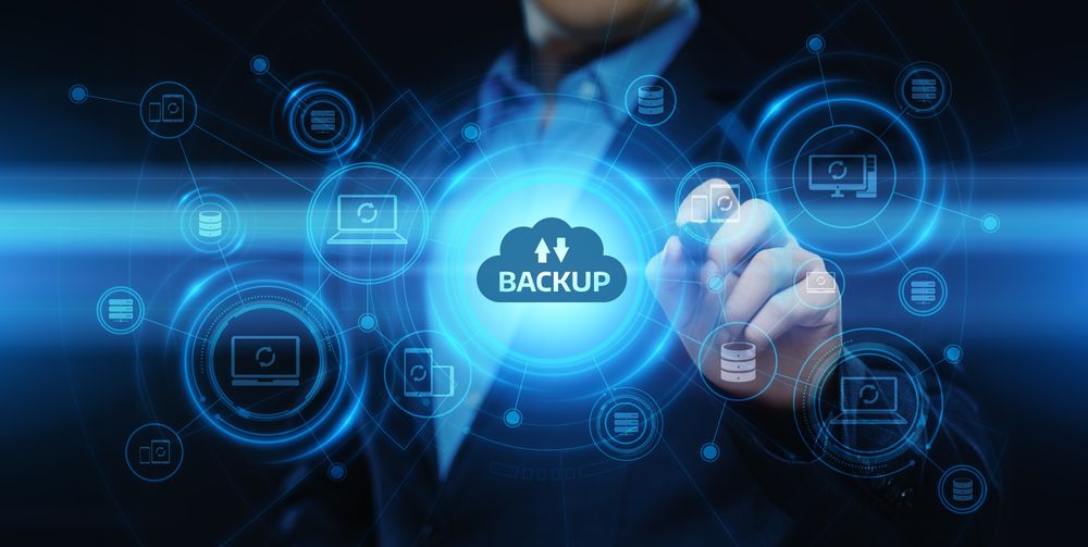 man in suit with modern tech cloud labelled backup