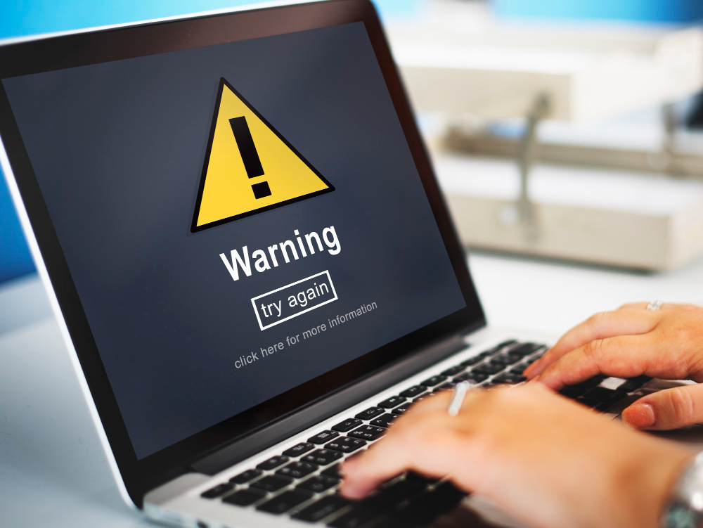 computer with a yello warning on screen